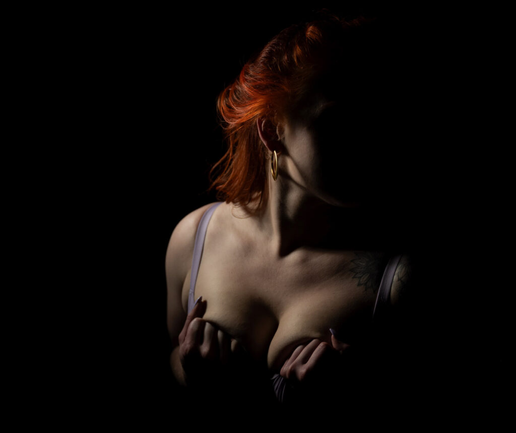 dark & moody boudoir portrait of red head woman in lingerie