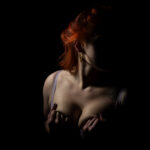 dark & moody boudoir portrait of red head woman in lingerie